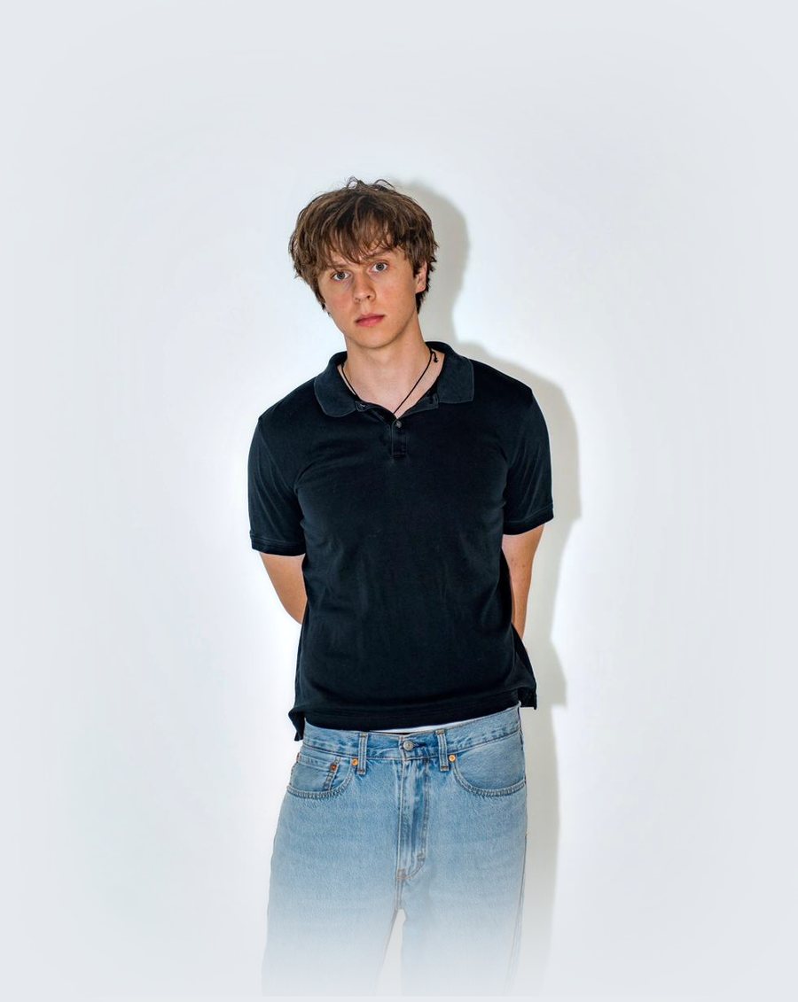 Cooper Hinshaw, full length, in a black polo and jeans.