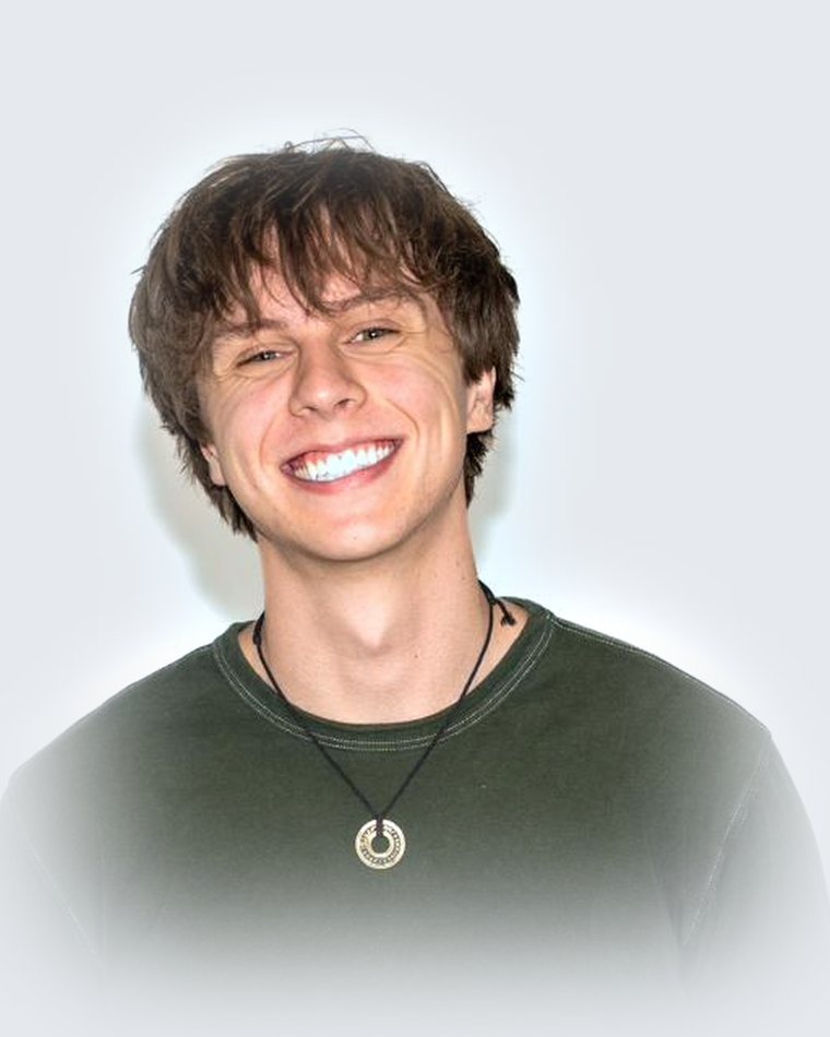 Cooper Hinshaw smiling, commercial headshot.